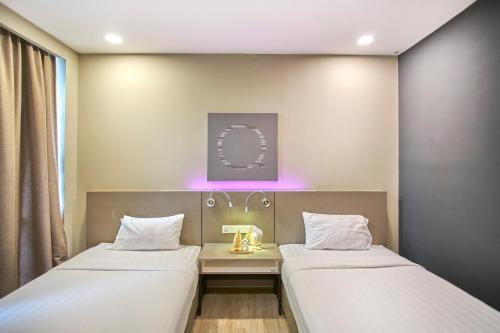 two beds in a hospital room with purple lights at Modern Studio Empire Damansara, Near 1 Utama & IKEA in Petaling Jaya