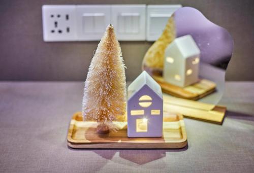 a small toy tree and a small house on a table at Modern Studio Empire Damansara, Near 1 Utama & IKEA in Petaling Jaya