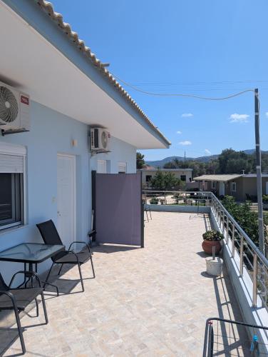 a patio with chairs and a table on a building at Pame Apartments Only Adults in Valanidorachi