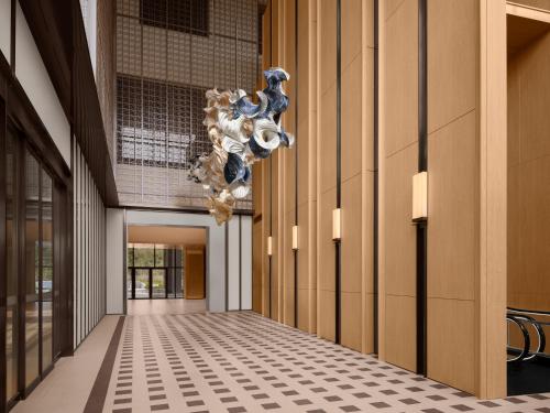 a hallway with a chandelier in a building at Shillamonogram Gangneung Hotel in Gangneung