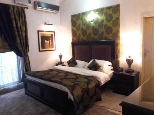 a bedroom with a large bed in a room at Bentley Boutique Hotel in Islamabad