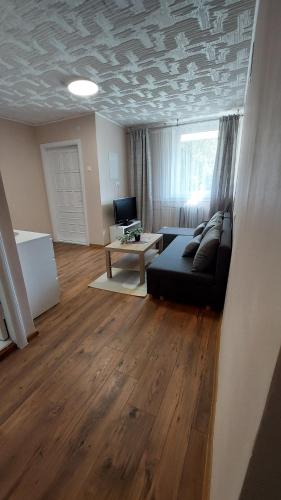 a living room with a couch and a table at "Veiklus Rietavas" apgyvendinimas in Rietavas