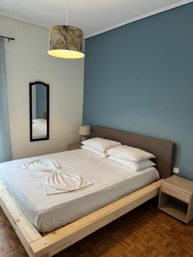 a bedroom with a large bed with a wooden frame at Almeta Apartment 3 in Chios