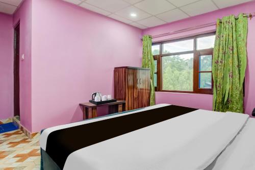 a bedroom with a bed and a window at Collection O Airport Road Solina in Srinagar
