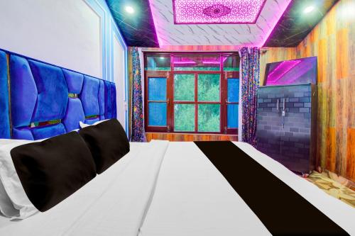 a room with a bed with a purple ceiling at Collection O Airport Road Solina in Srinagar