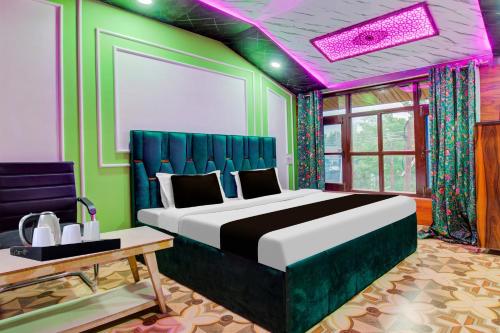 a bedroom with a large bed with a purple ceiling at Collection O Airport Road Solina in Srinagar