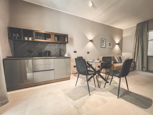a kitchen and dining room with a table and chairs at AF Apartments in Lecce