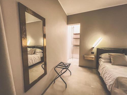 a bedroom with a mirror next to a bed at AF Apartments in Lecce