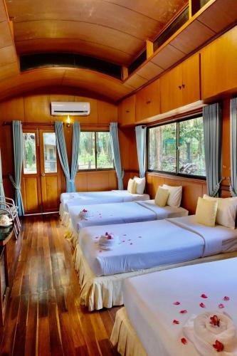a room with four beds with flowers on them at Kirirom Hillside Resort in Kampong Speu