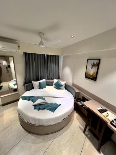 a bedroom with a large bed in a room at Hotel Comfort in Surat