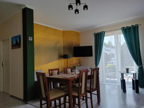 a dining room with a table and chairs at Noclegi -Chata Polska in Chrostkowo