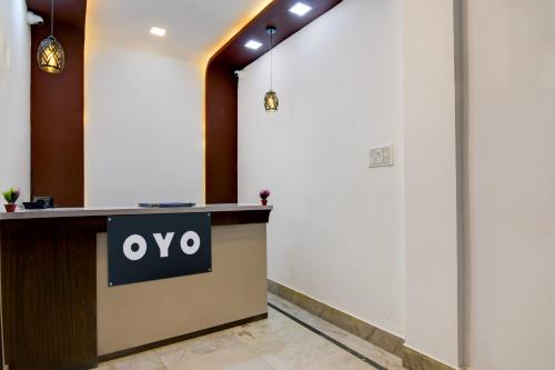 a reception desk in a lobby with an omega sign on it at Hotel O Stay Inn in Kolkata