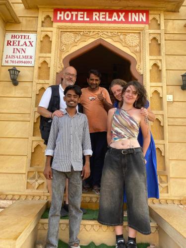 a group of people standing under a hotel relay inn at Relax Inn Jaisalmer in Jaisalmer