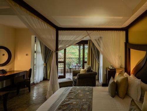 a bedroom with a bed and a living room at Enashipai Resort & Spa in Naivasha