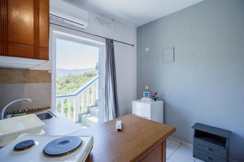 a kitchen with a sink and a window with a view at Velendzas Holidays in Alikanas