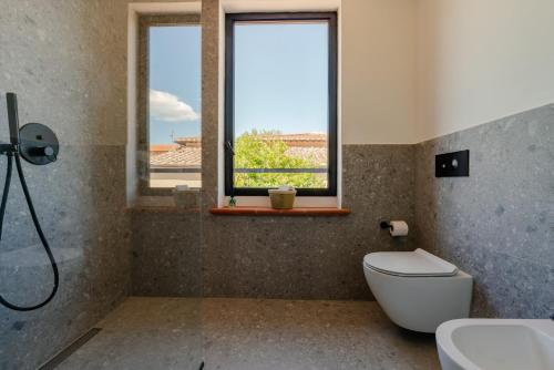 a bathroom with a toilet and a window at Tenuta Alela in Figline Valdarno