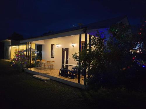 a small house with a patio at night at Chaba1 in Nakhon Nayok