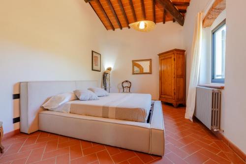 a bedroom with a large bed in a room at Tenuta Alela in Figline Valdarno