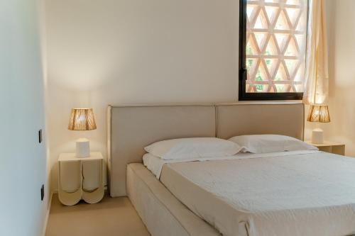 a bedroom with a bed and a window at Tenuta Alela in Figline Valdarno
