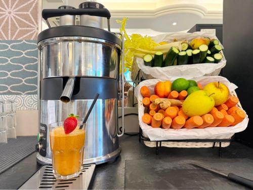 a blender sitting on a counter with fruits and vegetables at Hotel Monaco in Caorle