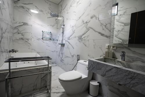 Un baño blanco con inodoro y lavabo. en Villa Maya, en Kerobokan