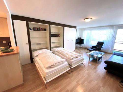 a room with a bed and a living room at Adler 82 in Leukerbad