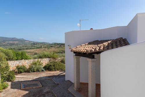 a view of a white building with a roof at Villa Paradisu in Alghero