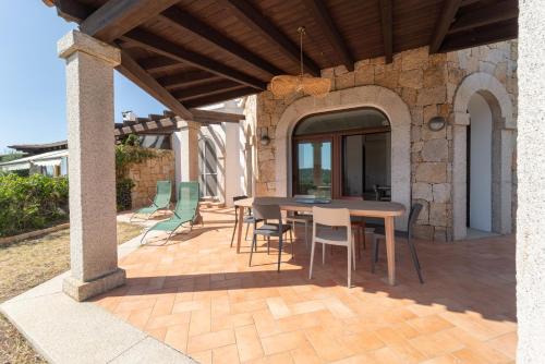 a patio with a table and chairs on it at Villa Paradisu in Alghero