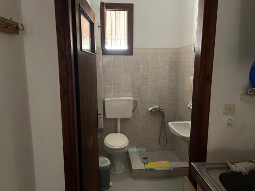 a small bathroom with a toilet and a sink at Matina's house in Samos