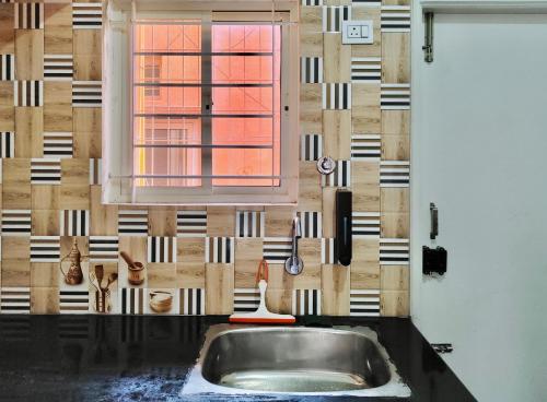 a kitchen with a sink and a window at Samuels Comfort Homes in Bengaluru
