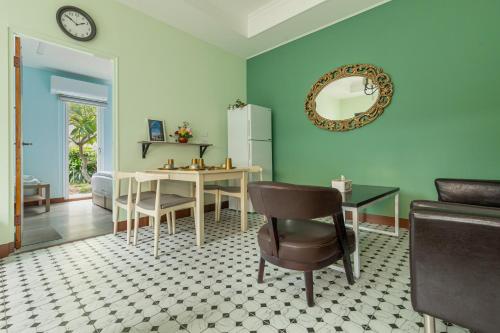 a living room with a table and a refrigerator at Zhe Juan Meng Tian in Sanyi