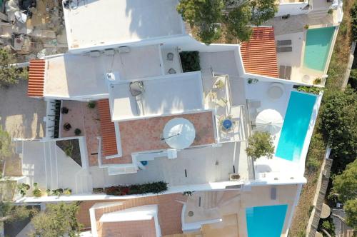 an aerial view of a white house with a swimming pool at JAMES SIB19 - luxury Cala Vadella villa with pool and stunning sea view in Sant Josep de Sa Talaia
