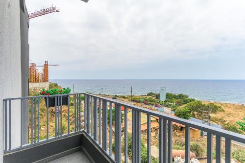 a balcony with a view of the ocean at Chalet 1 With Jacuzzi In Monsef in Al Ḩulwah