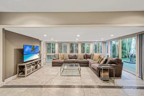 a large living room with a couch and a tv at Large home king bed by Dream Vacation unit BH in Fort Lauderdale
