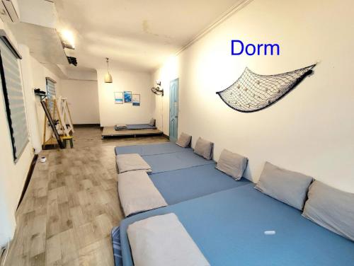 a room with a bunch of pillows on the floor at Homestay Quan Lan - BLUE by MAY5 in Quan Lạn