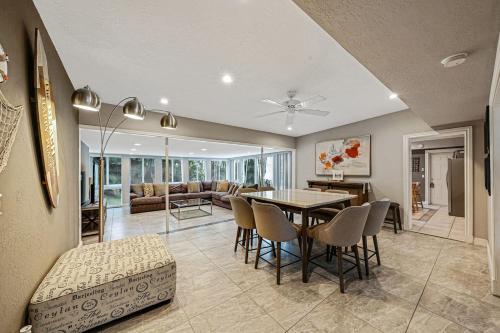 a dining room and living room with a table and chairs at Large home king bed by Dream Vacation unit BH in Fort Lauderdale
