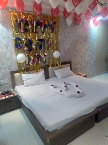 a bedroom with a bed with a bunch of balloons at The Moody Moon Hotel in Jaipur