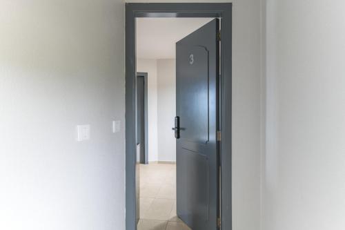 an open door to a hallway with a refrigerator at Chalet 1 With Jacuzzi In Monsef in Al Ḩulwah