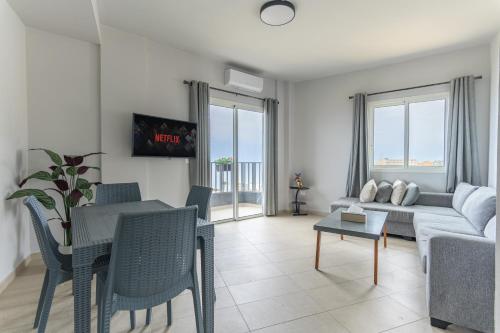 a living room with a couch and a table at Chalet 1 With Jacuzzi In Monsef in Al Ḩulwah