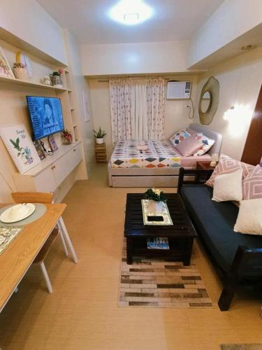 a small living room with a couch and a table at Avida Tower 3 L21 staycation rm 117 in Iloilo City