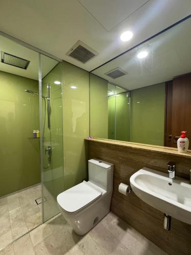 a bathroom with a toilet and a sink and a shower at Nest In The Sky in Kuala Lumpur