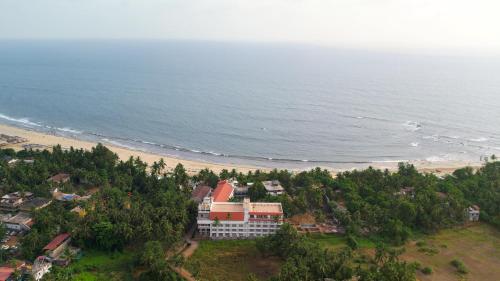 an aerial view of a resort and the beach at White Wharf Beach Resort Morjim Goa in Morjim