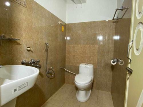 a bathroom with a toilet and a sink at Susanta Homestay By StayApart in Pedong