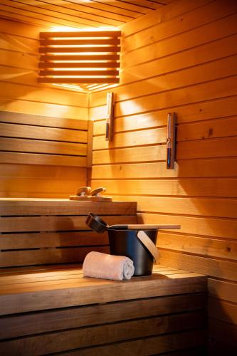 a sauna with a bucket and a roll of toilet paper at INNSiDE by Meliá Alicante Porta Maris in Alicante