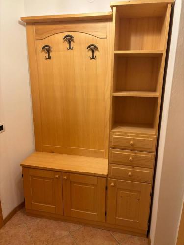 a wooden cabinet with two faucets on top of it at Appartamento Bosco al Sole in San Lorenzo in Banale