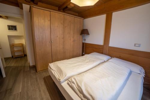 a bedroom with a large bed with a wooden ceiling at Residence Derby Club in Folgaria