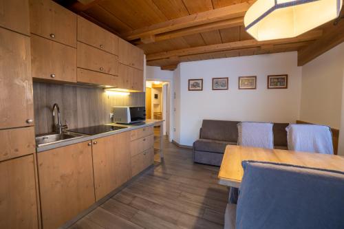 a kitchen with a sink and a couch in a room at Residence Derby Club in Folgaria