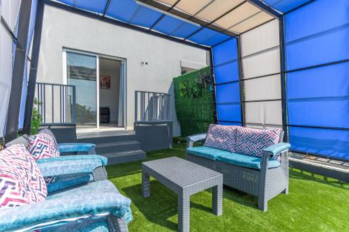 a group of chairs and a table in a yard at Chalet 1 With Jacuzzi In Monsef in Al Ḩulwah