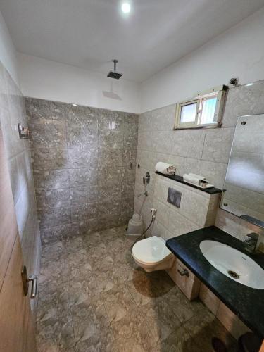 a bathroom with a toilet and a sink at Hotel Horizon Plaza in Gwalior