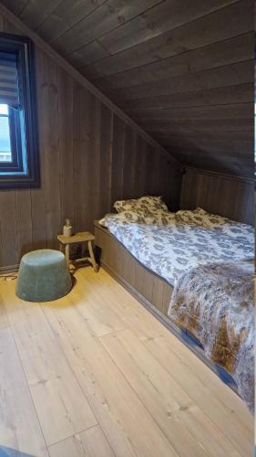 a bedroom with a bed and a table in it at Cabin with jacuzzi on Lifjell in Lifjell